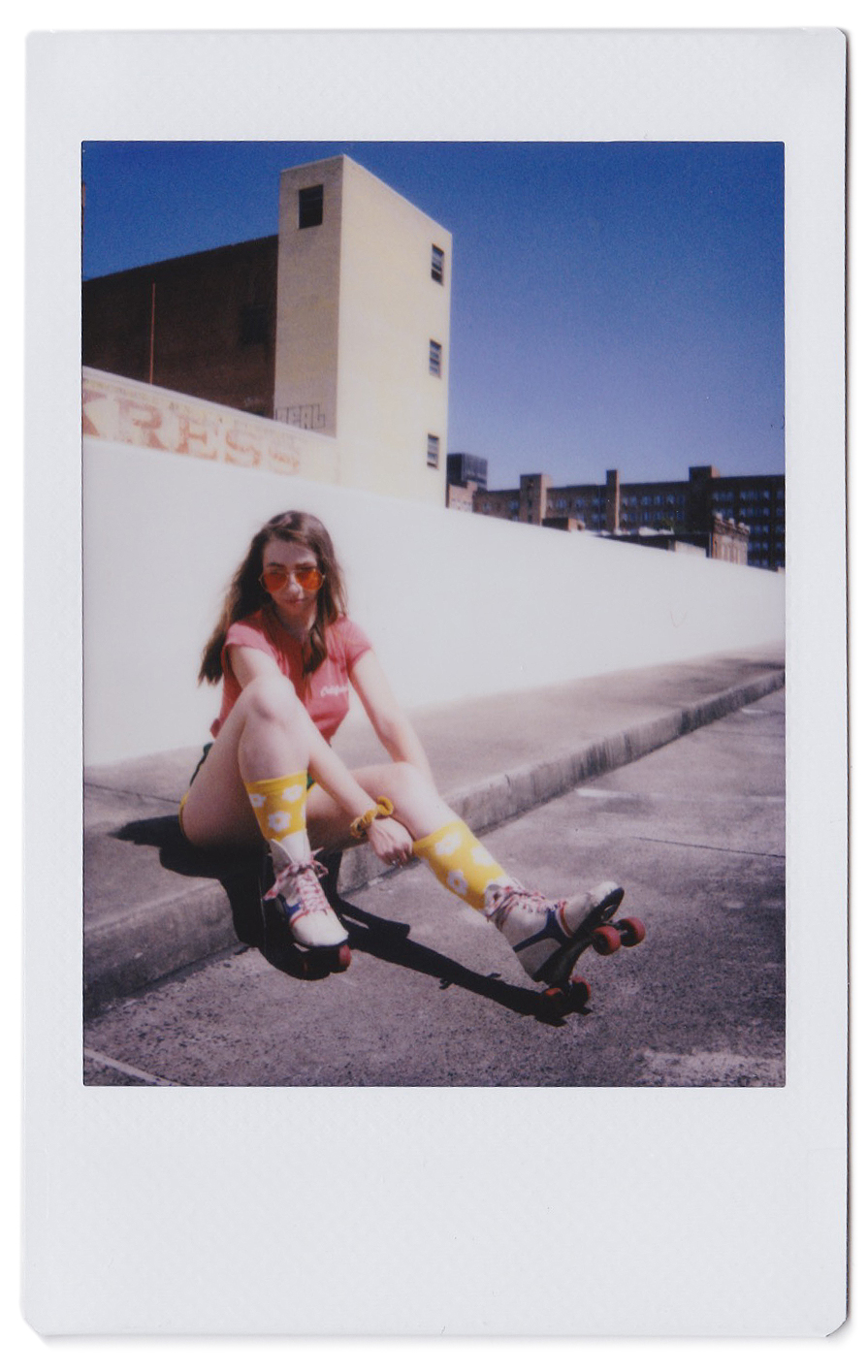 vintage polaroid scan of girl wearing roller skates