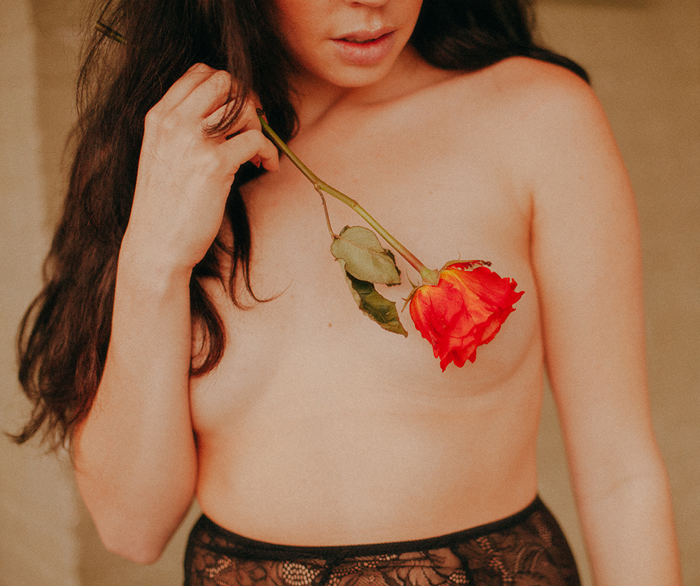 topless girl with rose covering her nipple