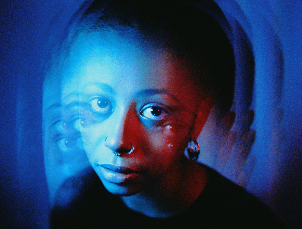 girl under blue neon light shot on cinestill 35mm